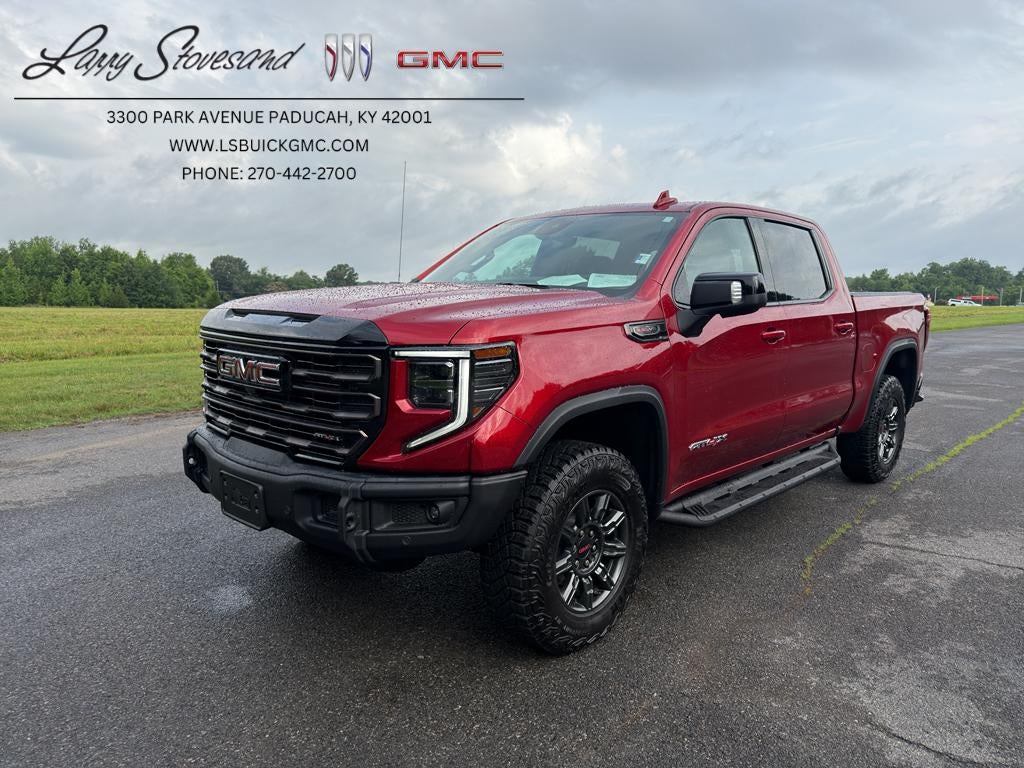 2024 GMC Sierra 1500 AT4X in Volcanic Red Tintcoat — front three-quarter view